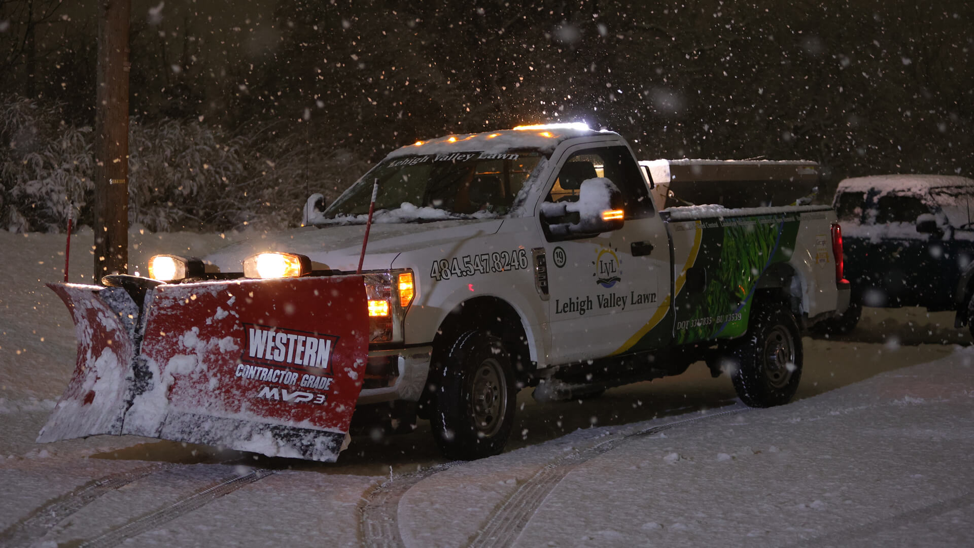 Lehigh Valley Lawn work truck clearing snow from a commercial lot in Macungie, PA.