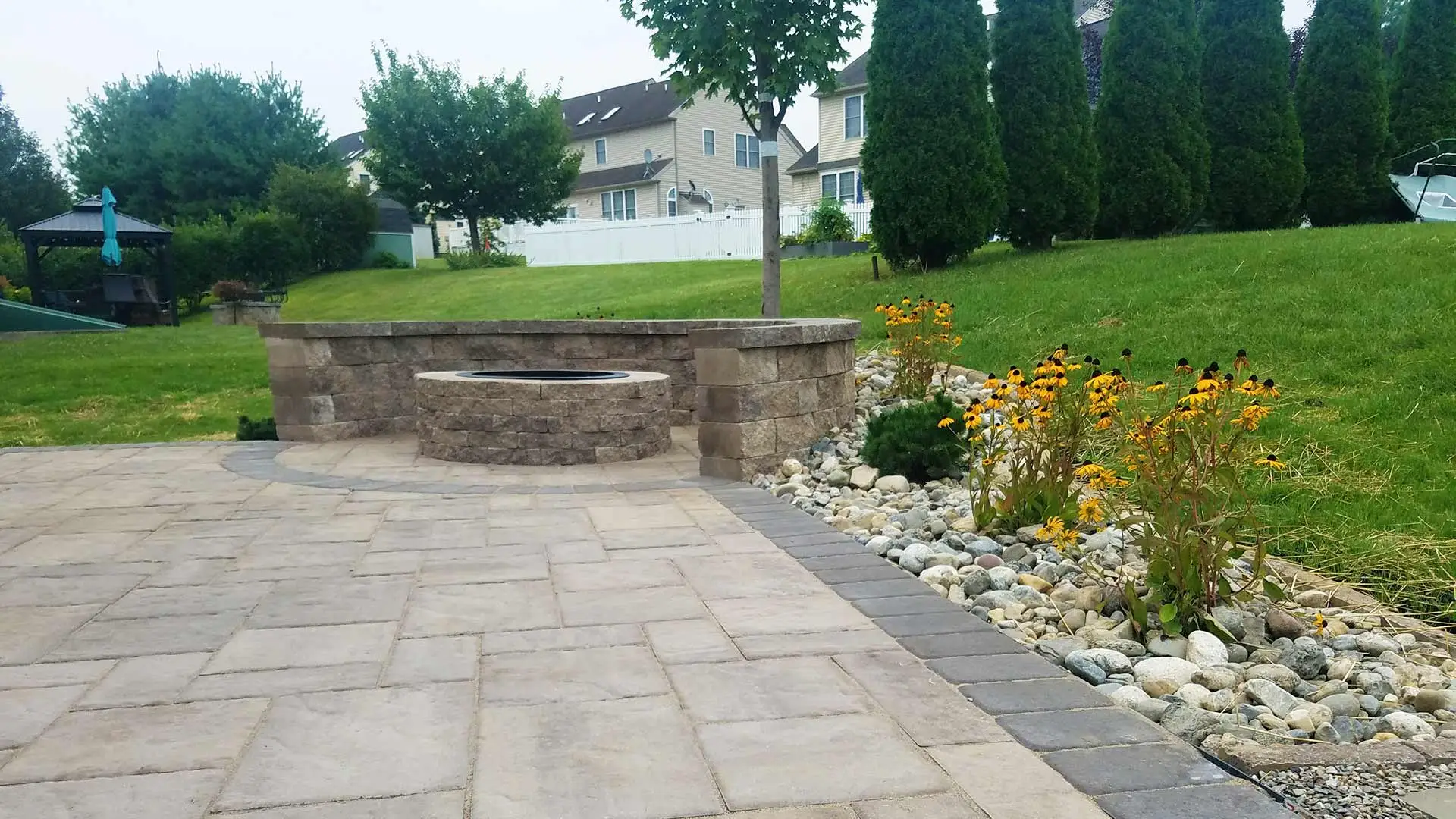 Custom fire pit and stone patio construction at a home in Allentown, PA.