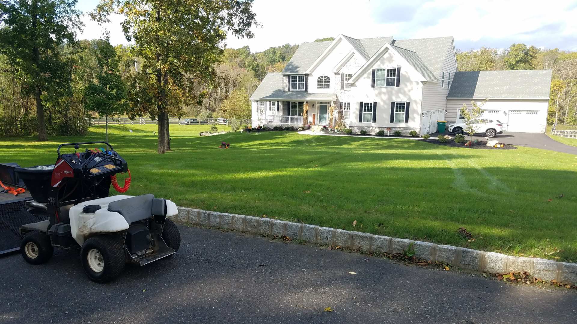 Green lawn in front of large white home in Fogelsville, PA.