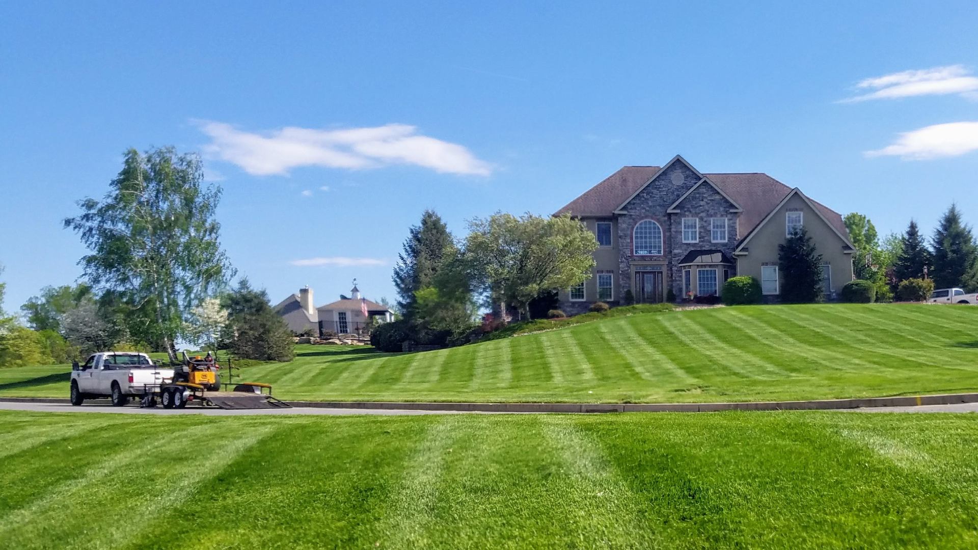 Lawn mowing patterns for large home front in Center Valley, PA.