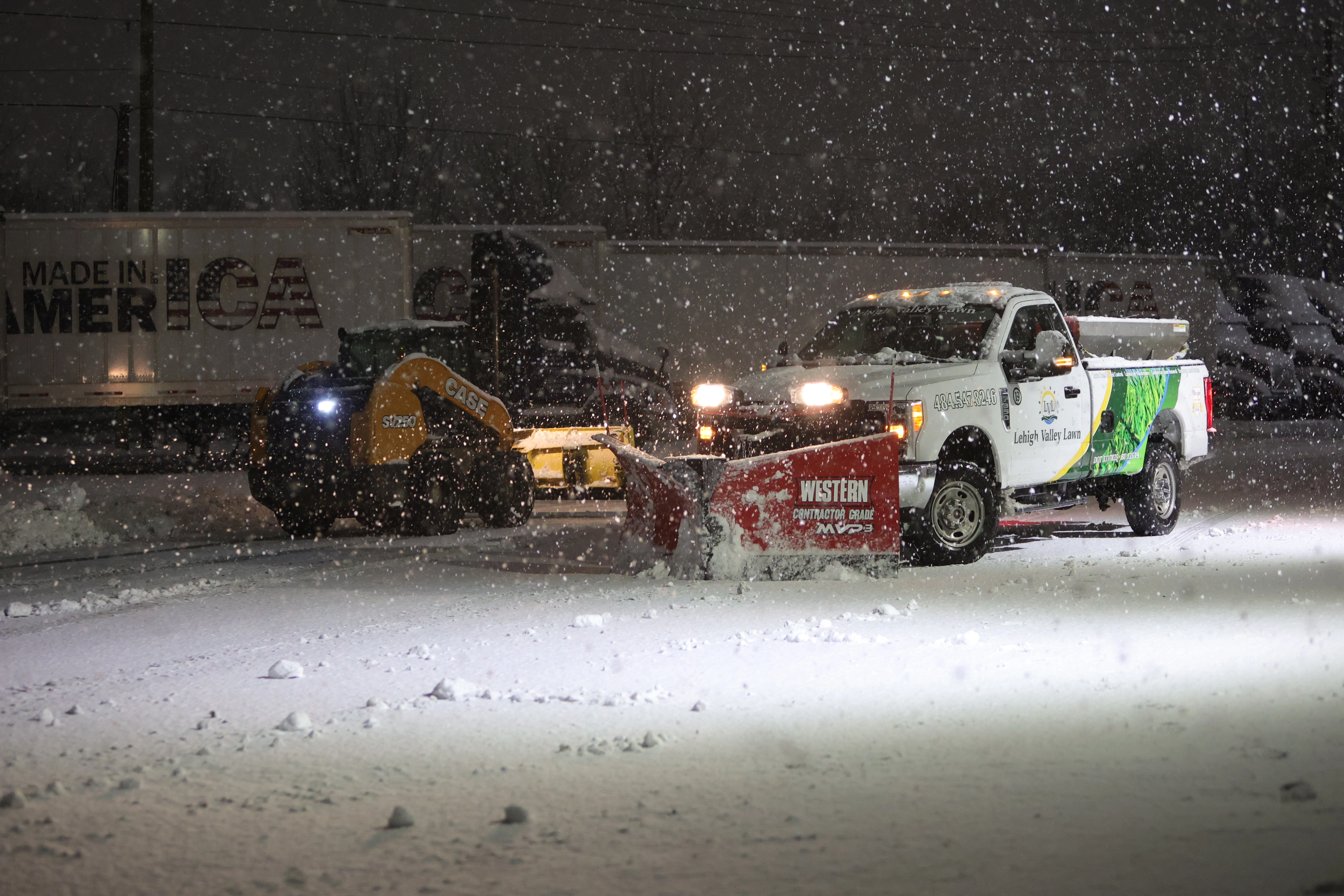 Lehigh Valley Lawn work truck clearing snow from a commercial lot in Macungie, PA.
