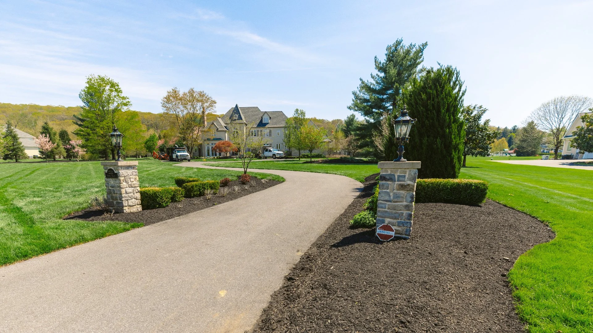 Walkway alongside landscaped garden and vibrant green lawn in Barto,PA