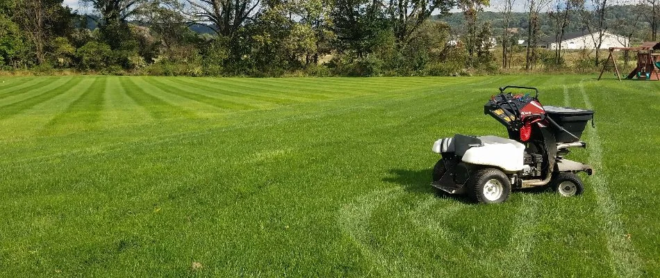 Lawn in Macungie, PA, with fertilizer spreader machine.