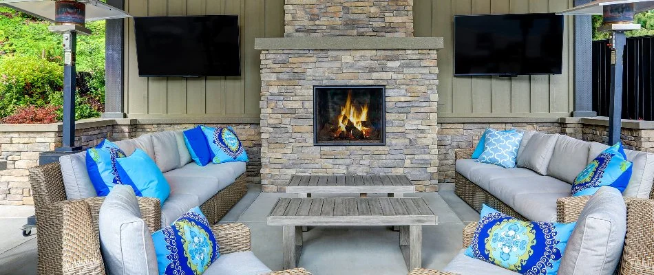 Furniture in front of a wood-burning outdoor fireplace in Northampton, PA.