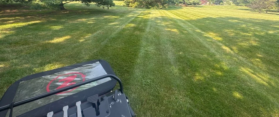 Granular spreader on a green lawn in Macungie, PA.