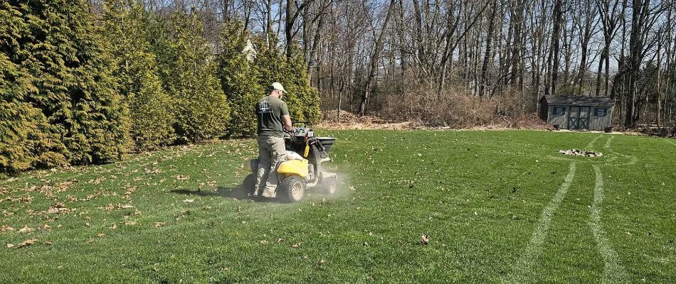 Man applying fertilizer on a lawn in Macungie, PA.