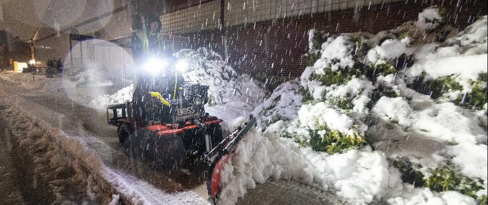 Man operating a snow plow during heavy snowfall in Macungie, PA.