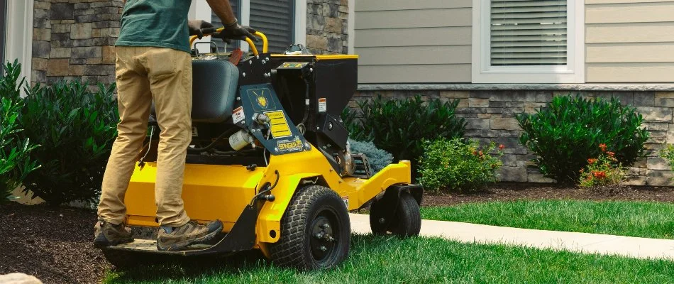 Professional spreading granular fertilizer on a lawn in Macungie, PA.