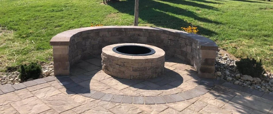 Small round fire pit in Northampton, PA, with a seating wall.