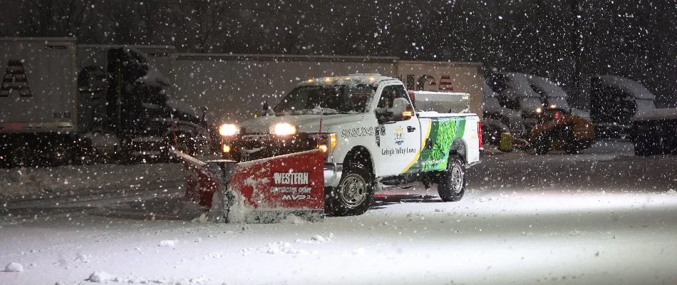 Snow plow clearing snow from a commercial property in Macungie, PA.