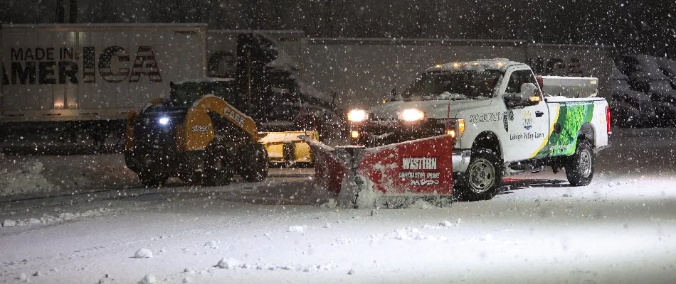 Snow plow clearing snow from a commercial property in Macungie, PA.