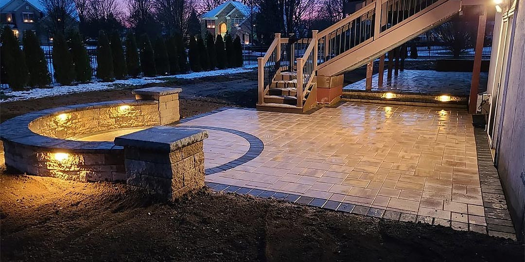 Custom patio with seating wall and outdoor lighting in Macungie, PA.