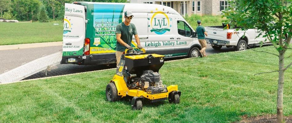 Employee core aerating a lawn in Orefield, PA.