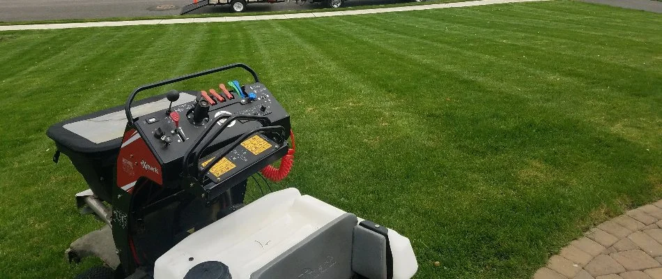 Green lawn with a fertilizer spreader on it in Macungie, PA.