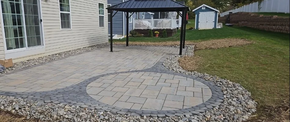 Patio in Hanover, PA, with decorative rocks beside a lawn.