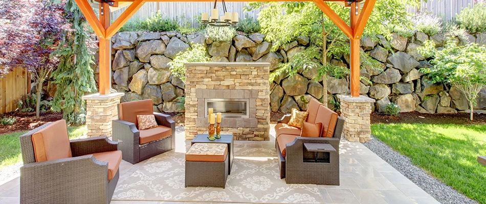 An outdoor living space complete with a seating area and fireplace in Orefield, PA.