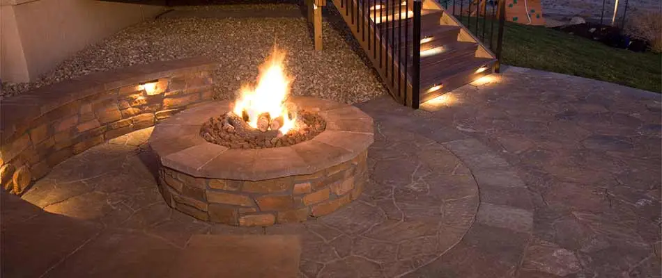 Stone fire pit with flames installed in Macungie, PA.