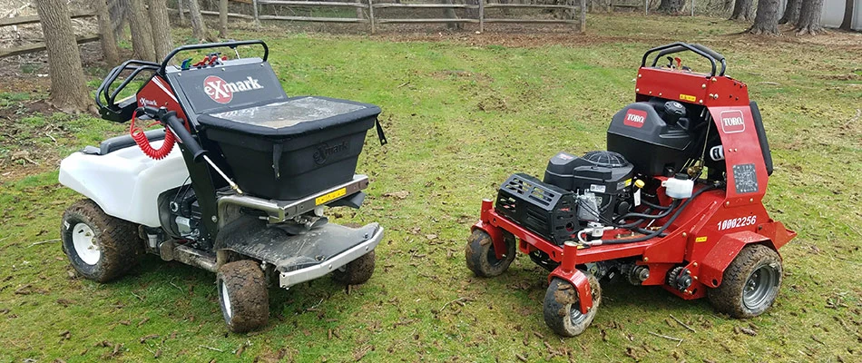 Two core aeration machines parked on an aerated lawn near Orefield, PA.